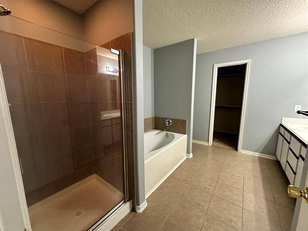 Primary bathroom with separate tub and shower