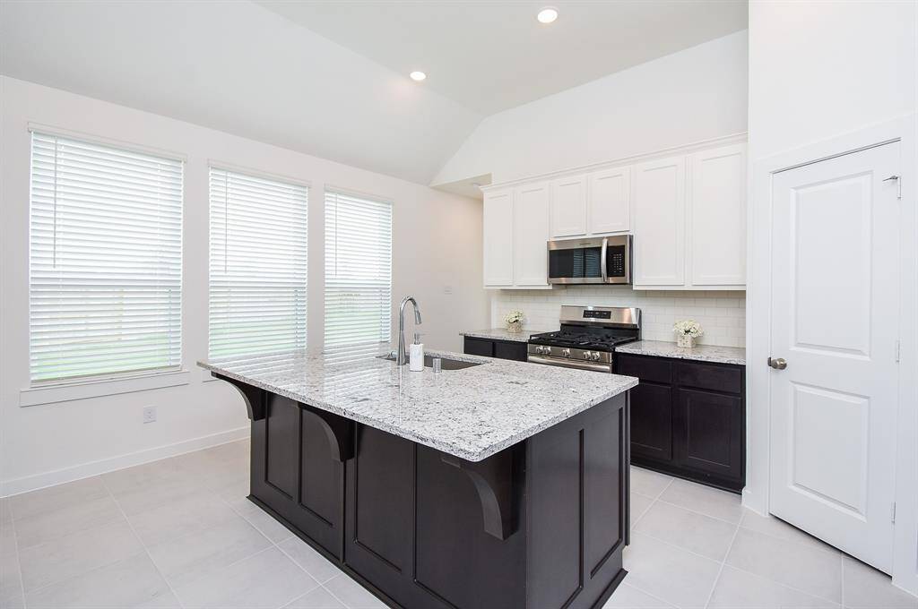 Another wall of windows lights this gorgeous kitchen area.