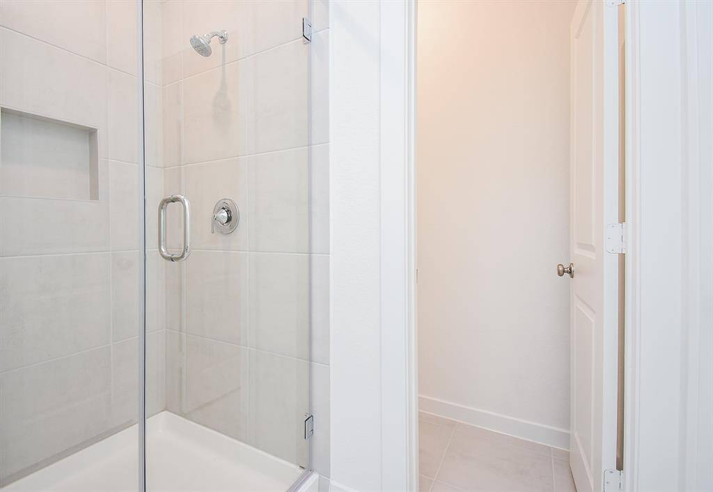 The roomy walk-in, glass enclosed shower sits right next to the door to your primary walk-in closet????