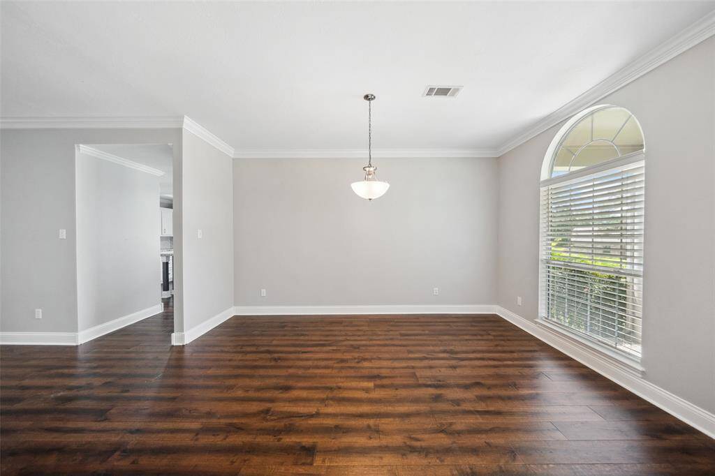 Formal dining area has hardwood flooring as well.