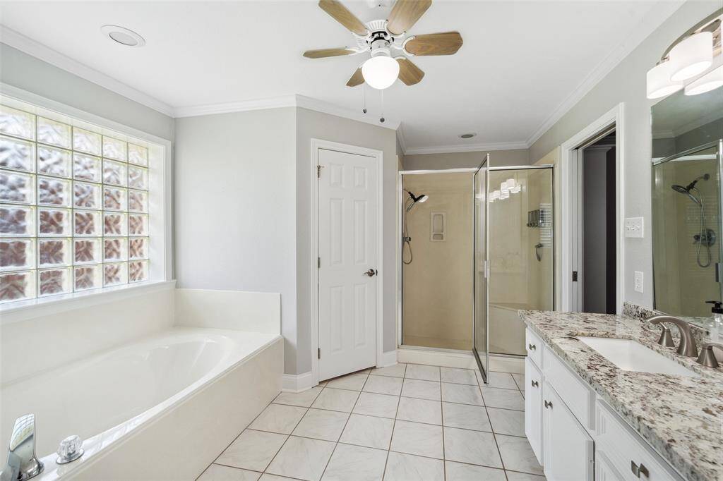 Master bath has a soaking tub, oversize walk-in shower, granite counters, and two sinks.