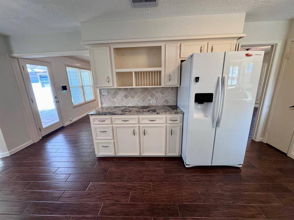 The kitchen is so pretty and has a functional butler's pantry.  Fridge included!