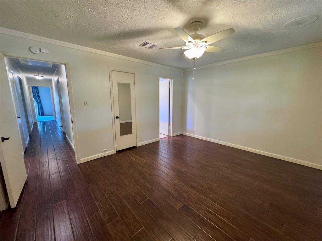 Primary bedroom with view down hallway