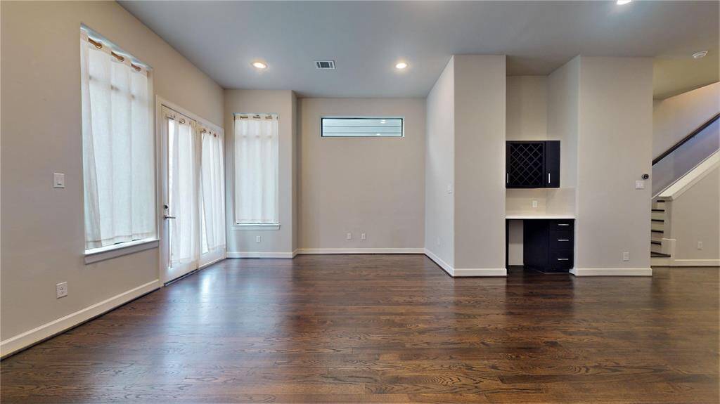 Gorgeous hardwood floors in the living/dining area... notice the dry bar area, and there is space for a wine chiller!