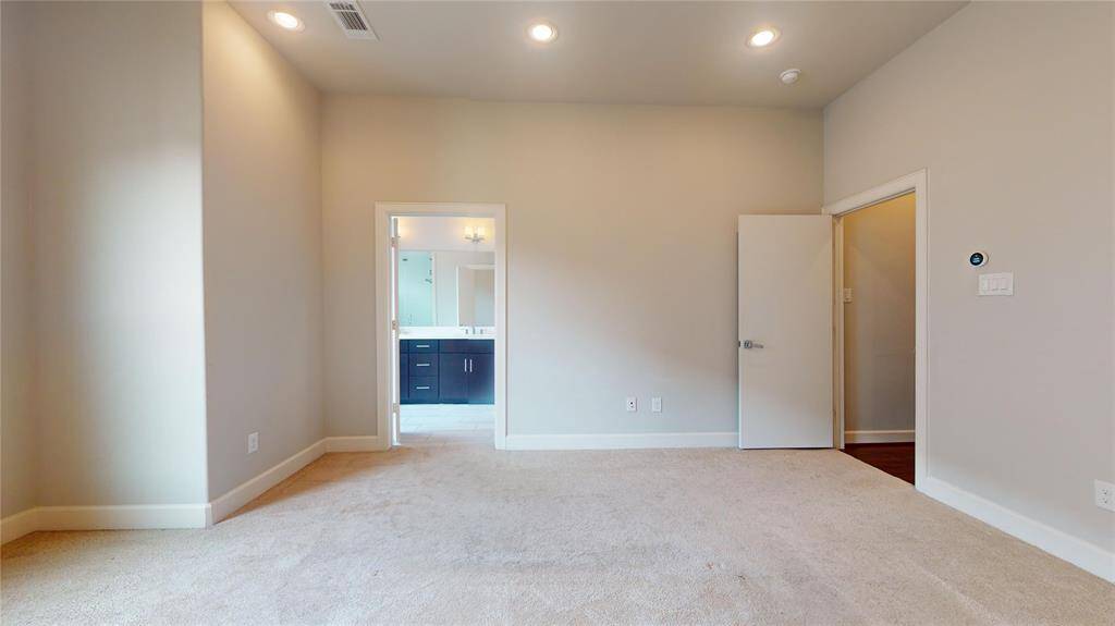 Here's the large primary bedroom with ample wall space for furniture, storage pieces, and decoration!