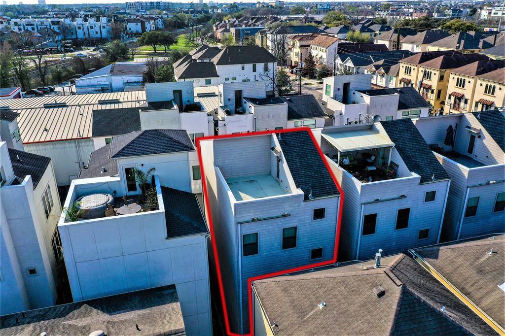 Aerial view of the large roof top terrace - it has been power-washed since this shot was taken, and is now ready to welcome your patio furniture and mini bar!