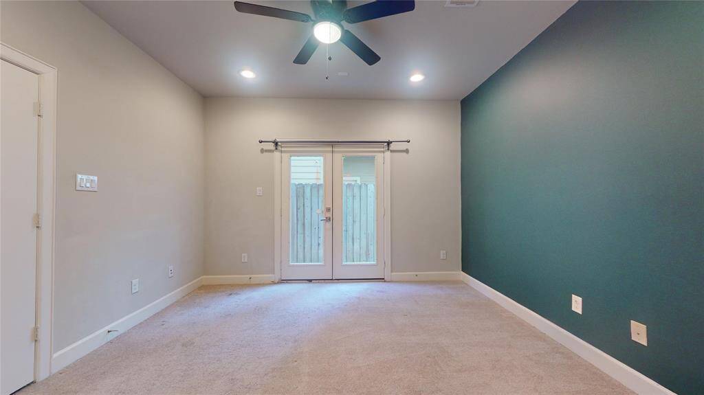 Another view of the first floor bedroom with the double patio door leading out...