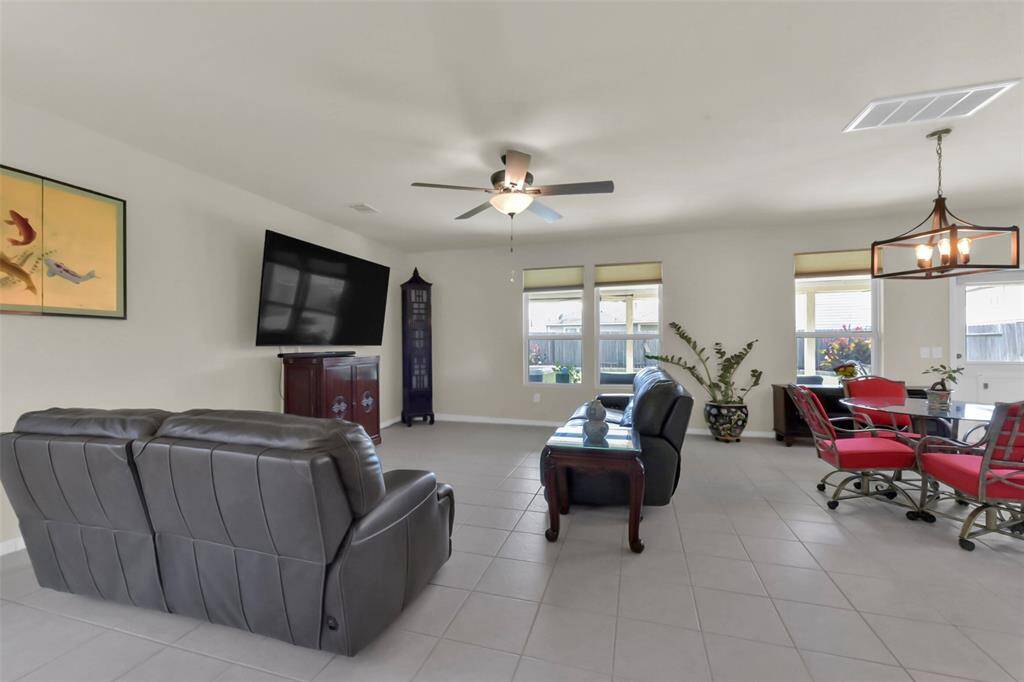 From the main living area, there's an open view into the breakfast nook and kitchen. A window in this space also offers a lovely perspective of the beautiful backyard.