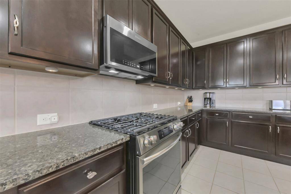 The updated kitchen with the island and stainless steel appliances