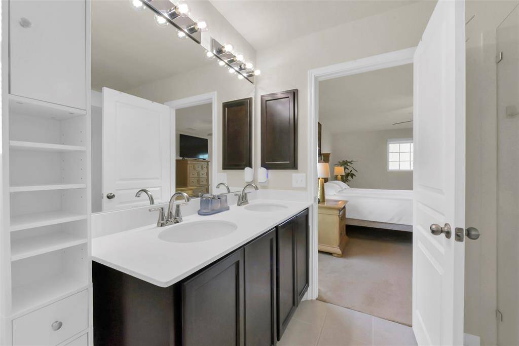 Designed with practicality in mind, the master bathroom features separate vanities, ensuring a smooth and stress-free routine