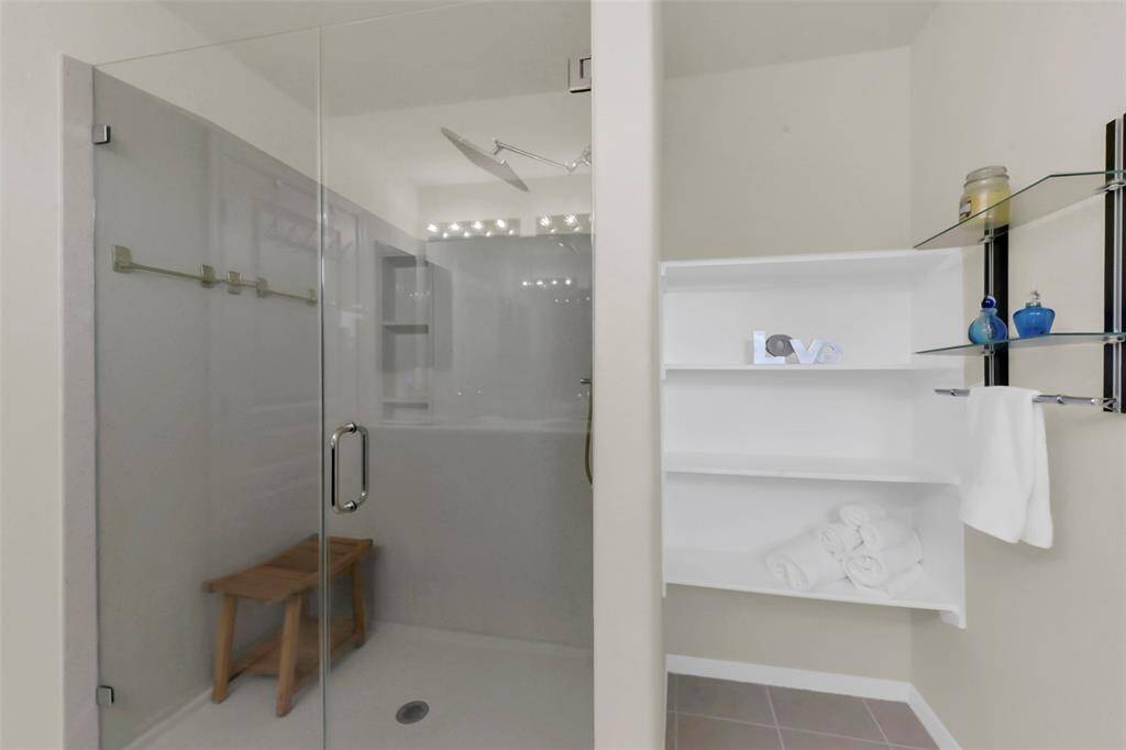Enjoy the convenience of this master bedroom shower, complete with a handy shelf for your essentials