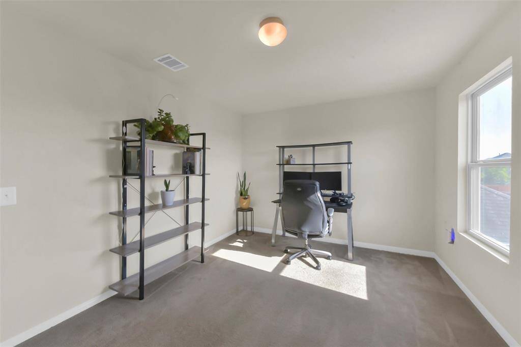 The fourth bedroom offers a bright and welcoming atmosphere with good natural light streaming in through its window