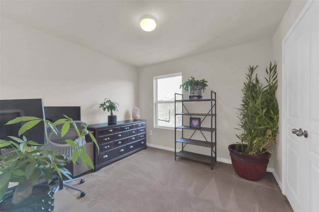 This comfortable third bedroom offers natural light from its window and includes a convenient separate closet.