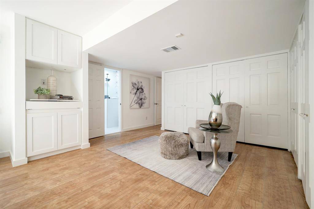 Sitting area in the primary and be sure to look at all the extra closet space and vanity