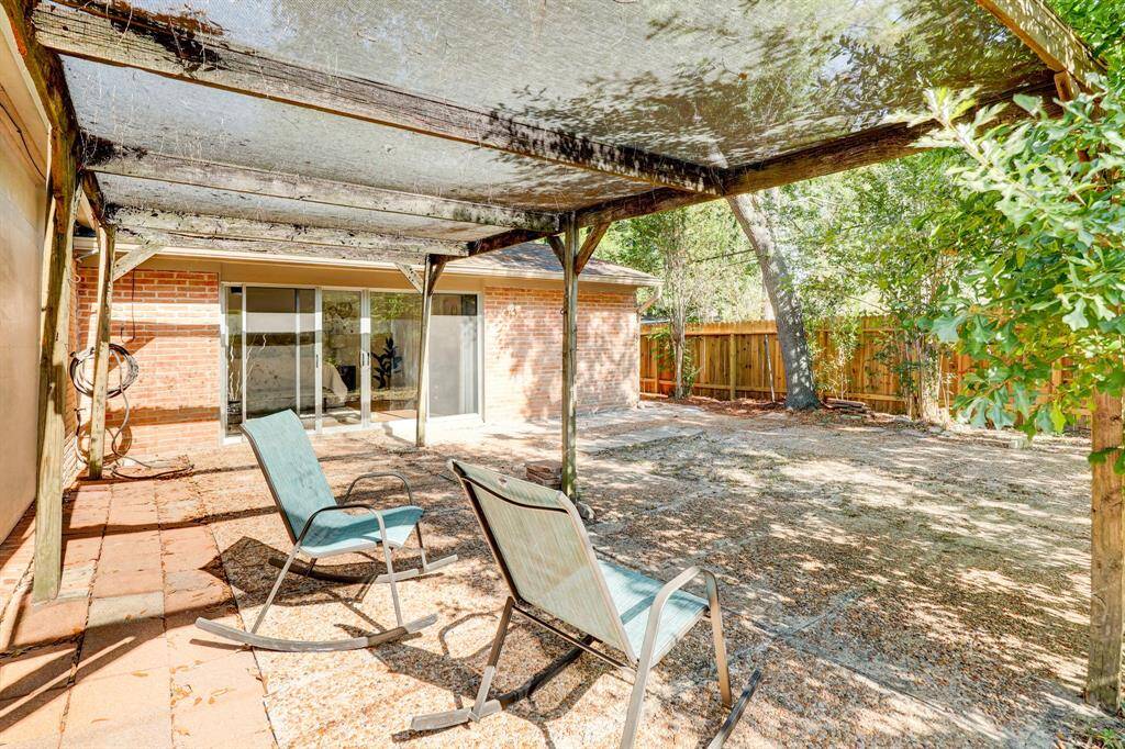 Outdoor patio with screens above and recent fence