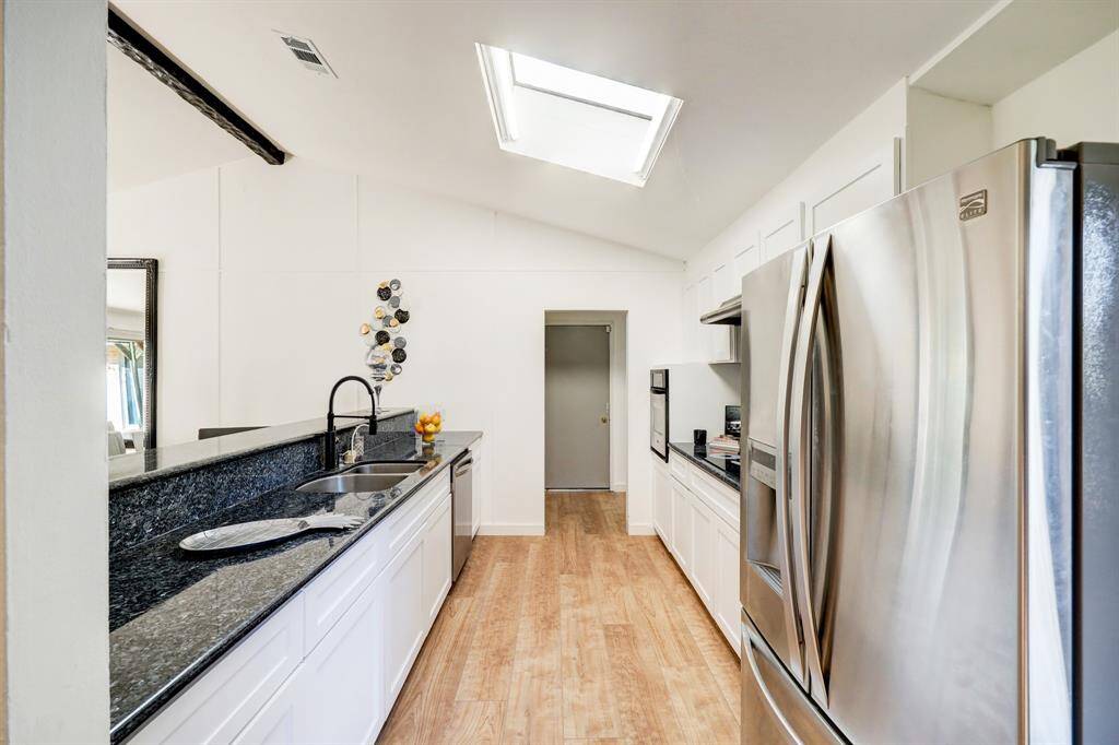 Galley kitchen with skylights to bring in all the natural lighting