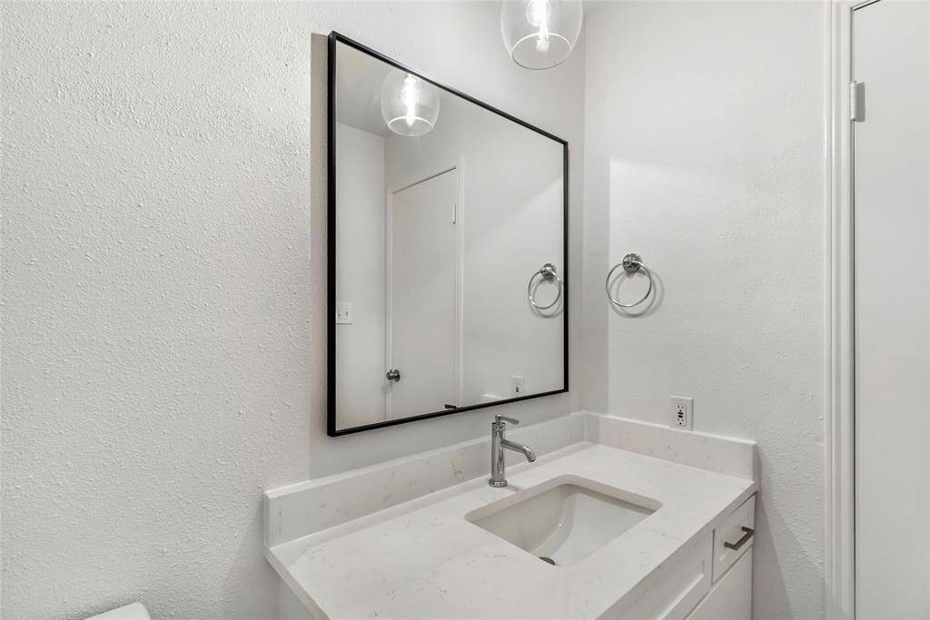 Elegant downstairs powder room with modern fixtures and a sleek design.