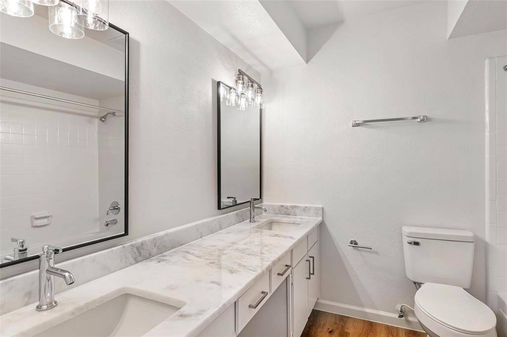 Primary bedroom ensuite with elegant quartz countertops and modern fixtures.