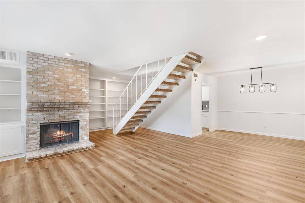 Beautiful brick fireplace next to built-ins function as the center point for the living room.