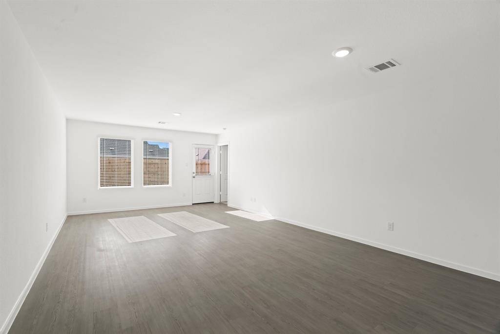 The back of the home is where you'll find the primary bedroom and entrance to back yard.
