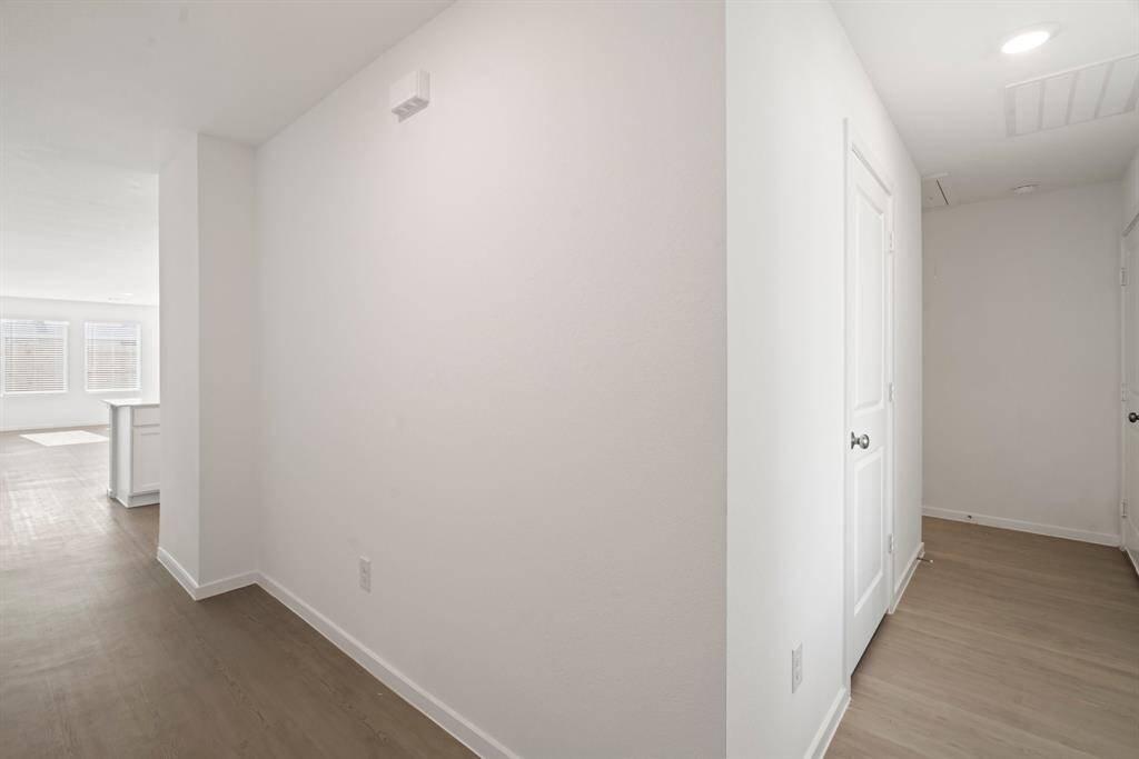 Front entrance with hallways that lead to main living area and separate hallway for guest rooms.
