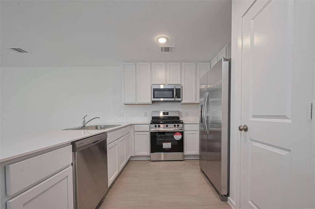 Kitchen at center of home with all new appliances.