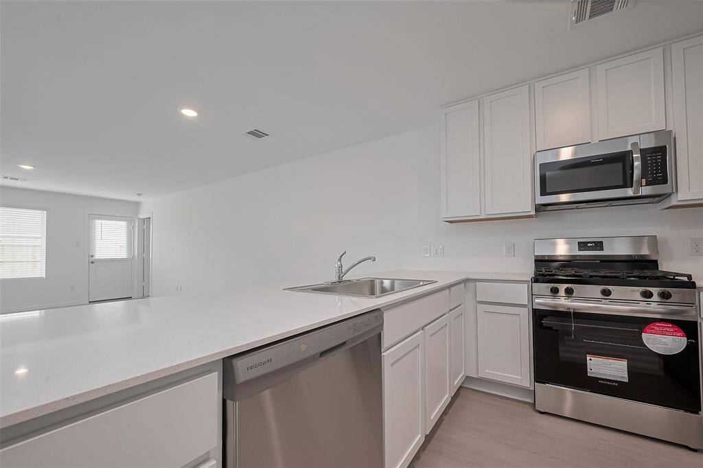 Quartz counter top that separates kitchen from main area.