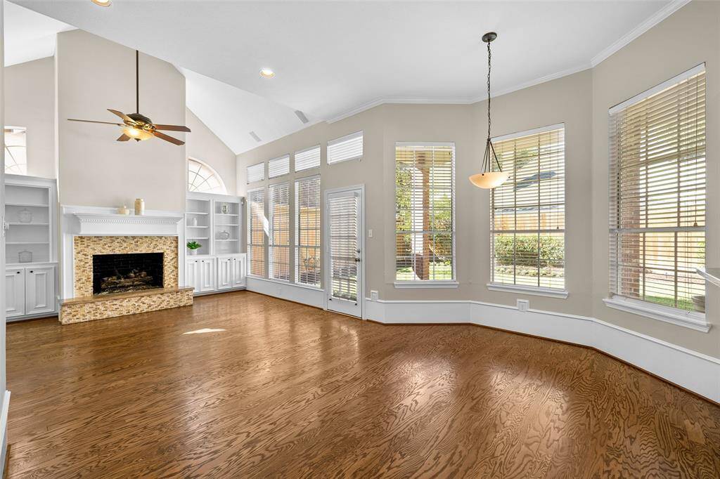 Fabulous den and breakfast area with continuation of the beautiful wood flooring and sparkling natural light provided by the windows and French door overlooking the back yard.