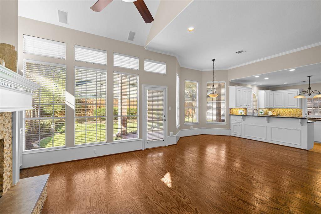 View of open-plan living area with view of modern kitchen.  This is a perfect space for gathering and entertaining.