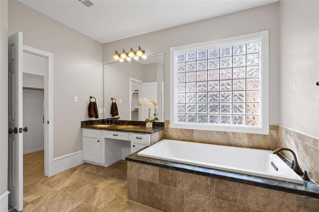 Luxurious tub in primary bath provides a perfect place for a soak at the end of your day.
