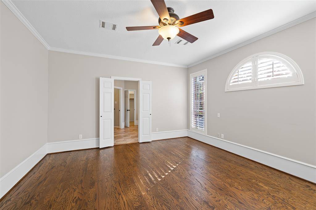 Primary bedroom with doors leading to primary bath.