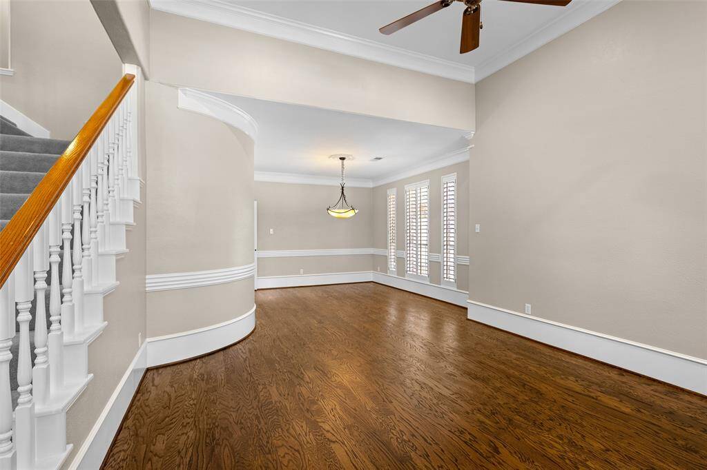Spacious, well-lit space for living and dining room with beautiful flooring.