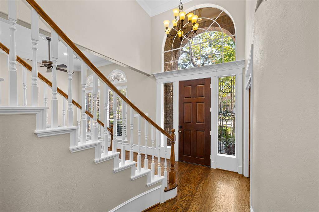 Natural light fills this beautiful entryway with high ceilings and lovely chandelier.