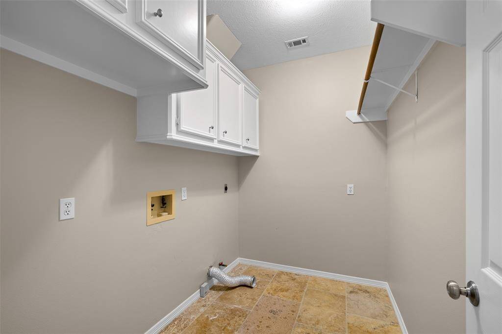 View of large utility room with built-in cabinetry.