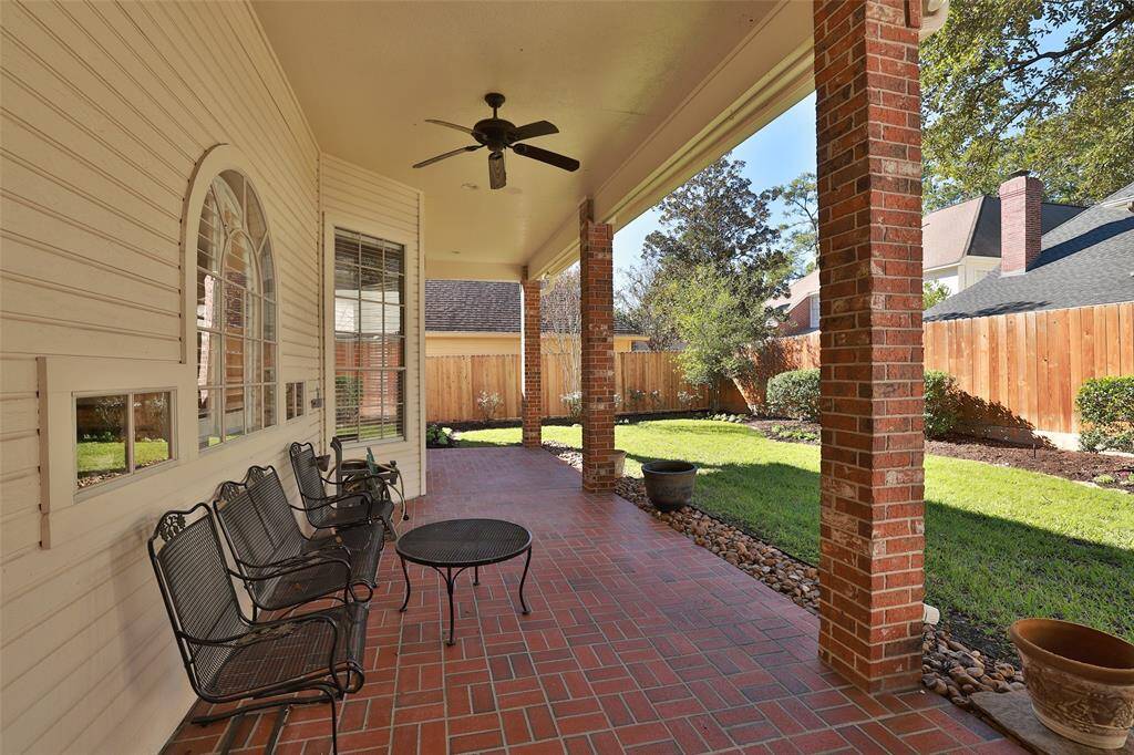 Lovely brick floored covered back porch provides a perfect space for relaxing and entertaining.