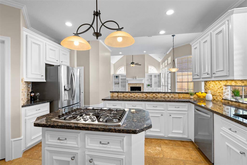 Large island with gas stove make this kitchen a chef's dream.