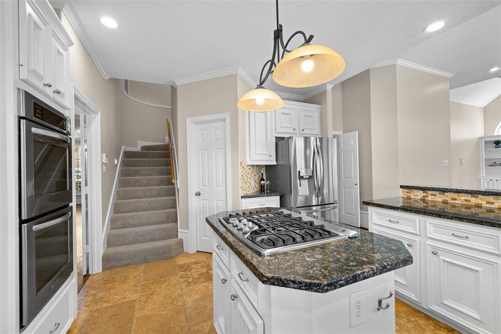 Another view of kitchen with secondary stair case.