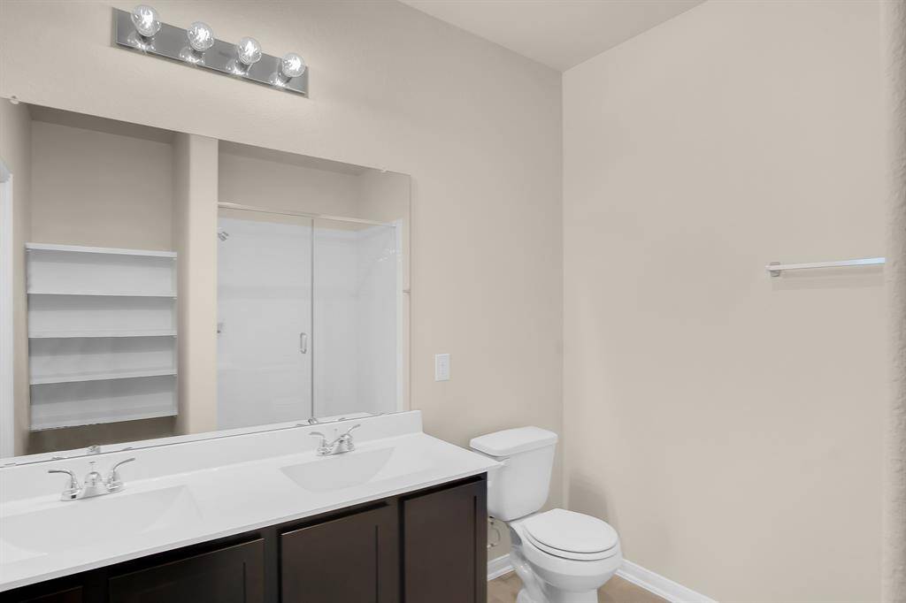 Double sinks in primary bathroom with super shower