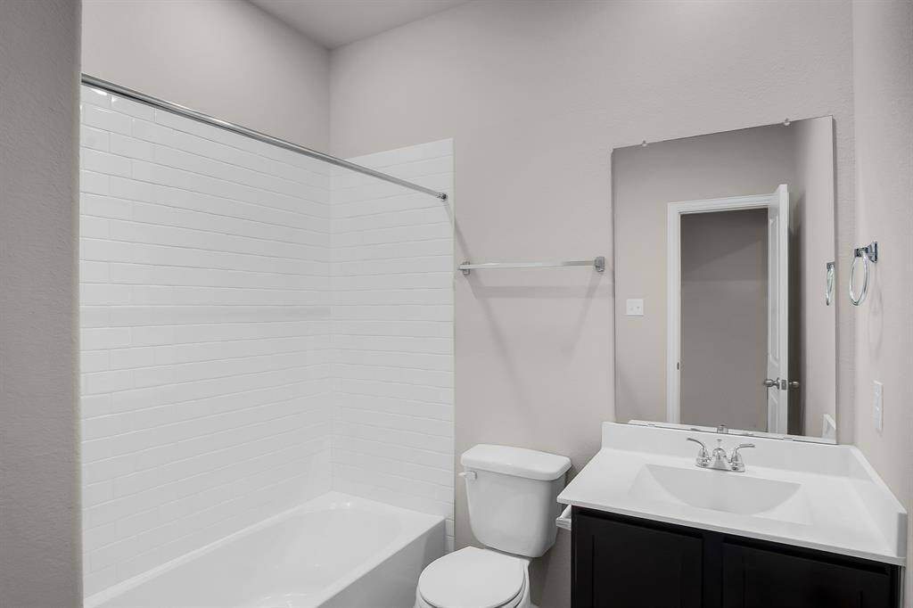 Full bath with tub and shower combo located between second and third bedrooms