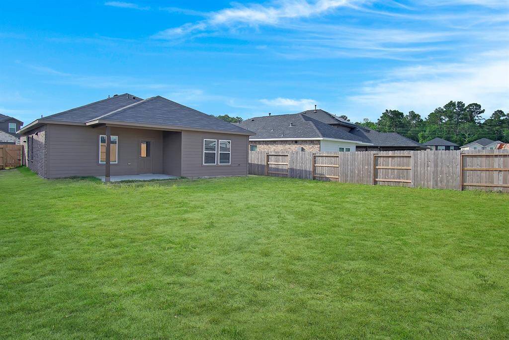 Covered patio, perfect for enjoying morning coffee, grilling, and hosting! *Grass has been virtually enhanced for visualization purposes*