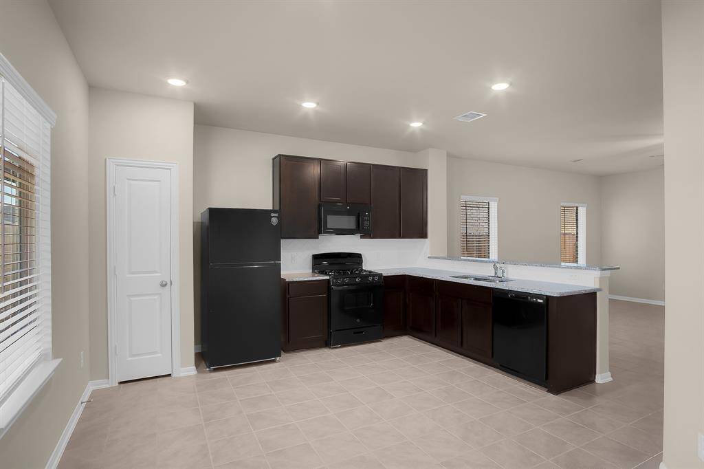 Beautiful, modern kitchen equipped with a microwave, dishwasher, stove/oven, and a refrigerator!