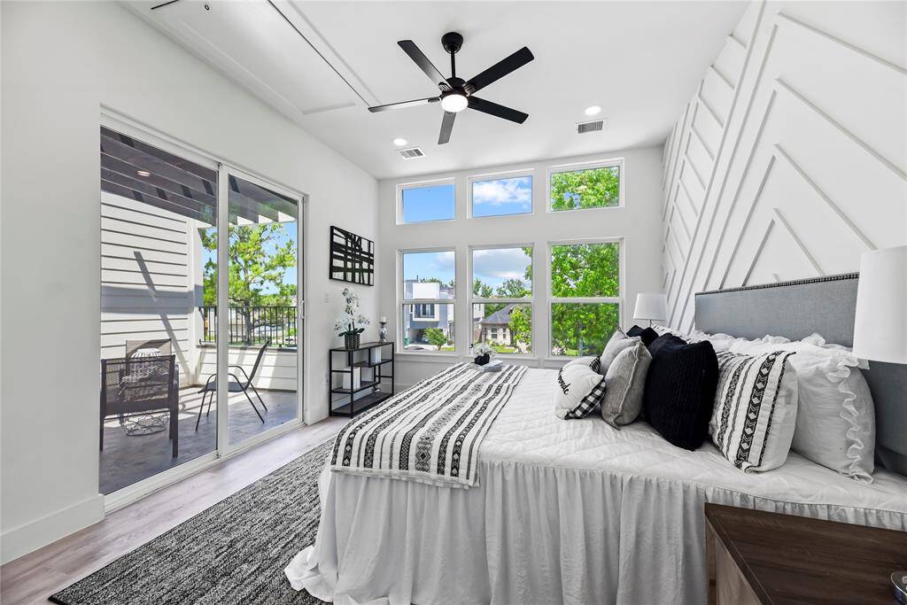 This bright, airy primary bedroom is full of natural light thanks to the large windows. The modern geometric accent wall adds a stylish touch, and you’ve got direct access to a cozy balcony—perfect for morning coffee or winding down in the evening.