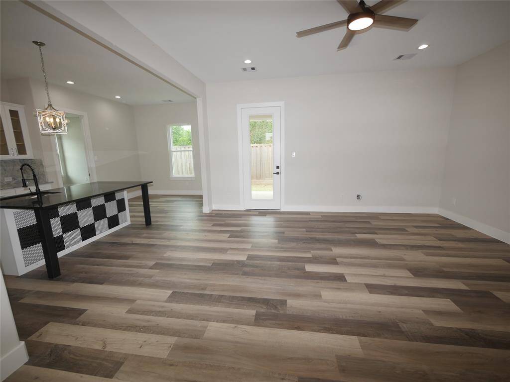 BIG OPEN LIVING ROOM WITH VIEW OF KITCHEN AND DINING.