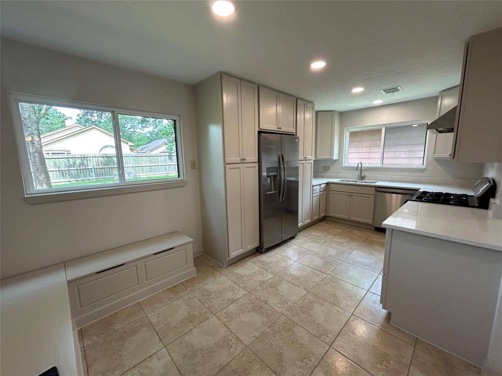 Look at all that storage and custom built-in bench seating with extra storage. Stainless Steel Appliances and Quartz Counter tops