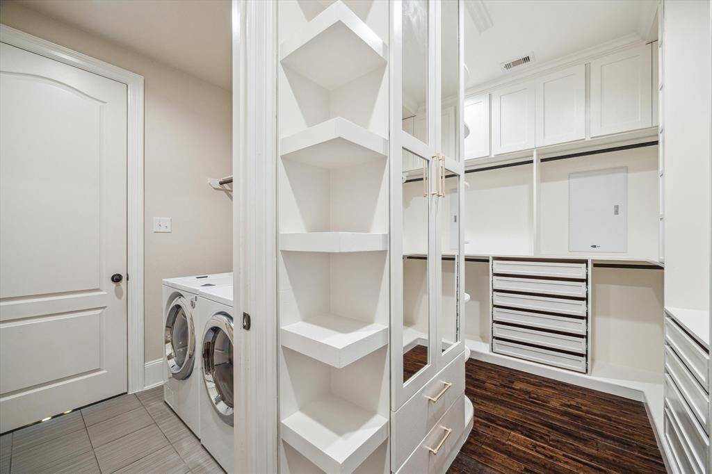 Step into a spacious walk-in closet with custom cabinetry that extends all the way to the ceiling—offering smart storage and a polished look. Conveniently located right next to the utility room for everyday ease.