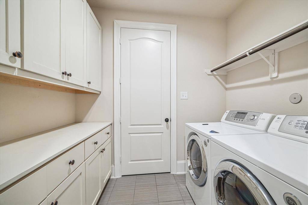 The utility room comes fully equipped with a washer and dryer, plus additional cabinetry for extra storage—keeping everything neat, tidy, and within reach.
