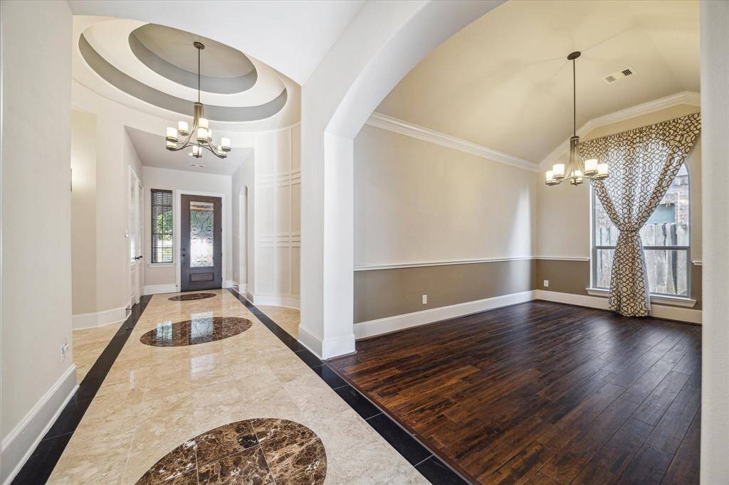 Make a grand first impression with the Westin signature tray ceiling, elegant accent walls, and upgraded marble flooring that flows through the entry and hallway—leading seamlessly into the formal dining room.