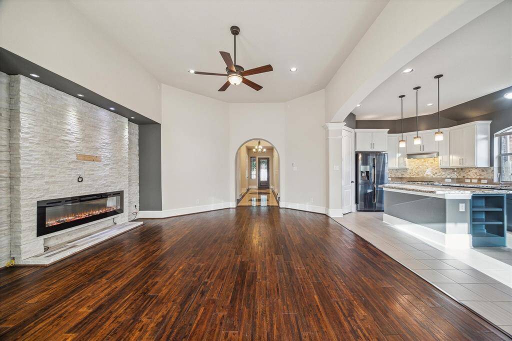 At the end of the hallway, the home opens up to a bright and spacious living room and kitchen—designed with comfort, connection, and everyday living in mind.