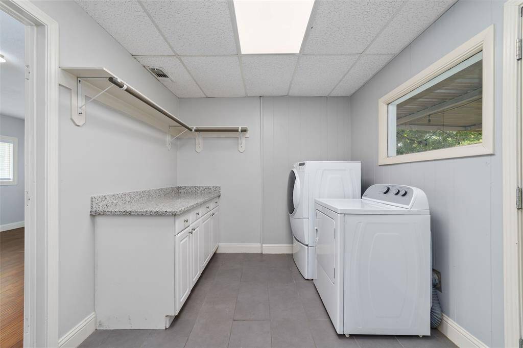 Large utility room with shelves and cabinets