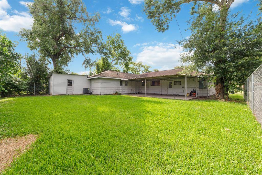 Spacious backyard with covered patio and large shed